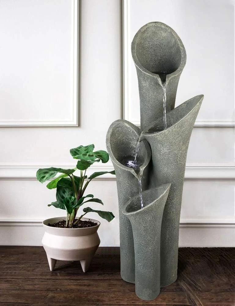 elephant birdbath fountain in landscaped backyard